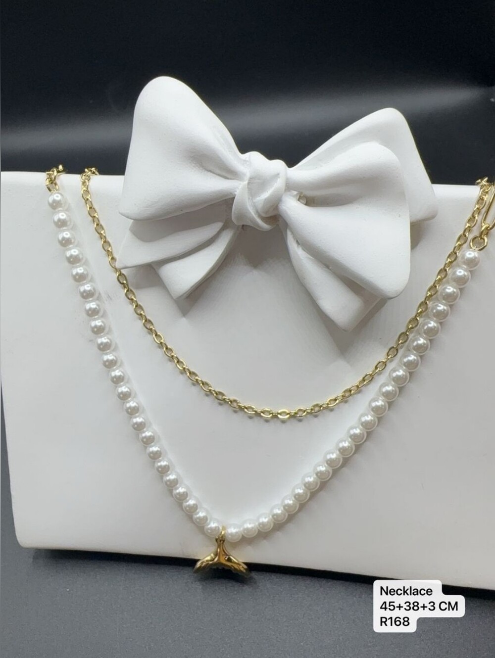 Double chain necklace with one gold link chain and one white pearl chain with me